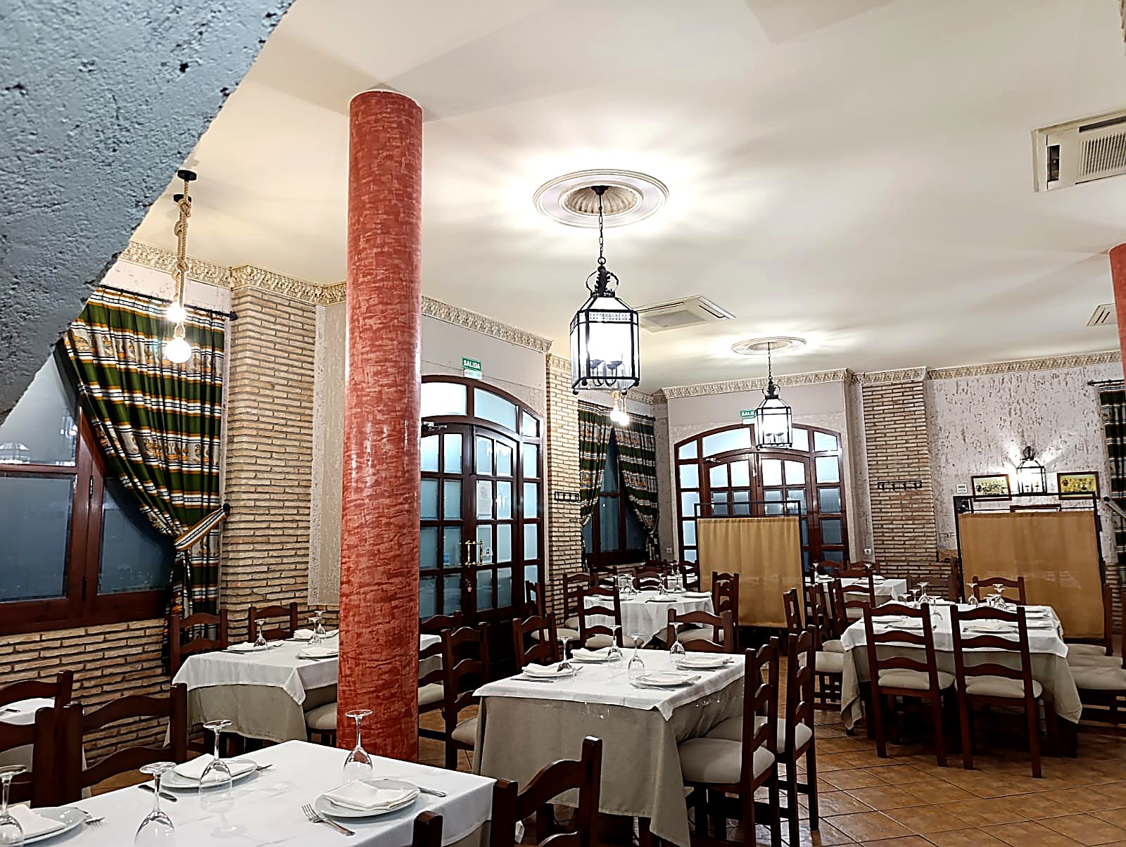 Salón principal del Mesón Juan Antonio con mesas vestidas para una celebración